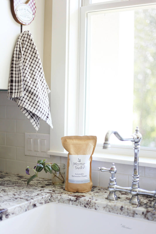 Nice picture of Mama Suds Automatic Dishwashing Powder sitting next to a tastefully retro kitchen sink